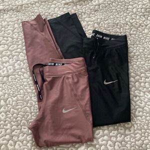 Nike Dri-Fit women’s running leggings. Both size S. One black, one dusty rose.
